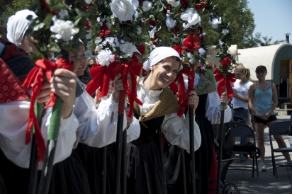 Izar Bicandi peeks at the crowd as the Oinkari Basque Dancers take the stage at the San Inazio Festival in Boise.