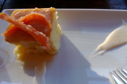 Essence of grapefruit cake topped with candied grapefruit and grapefruit glaze swoosh
