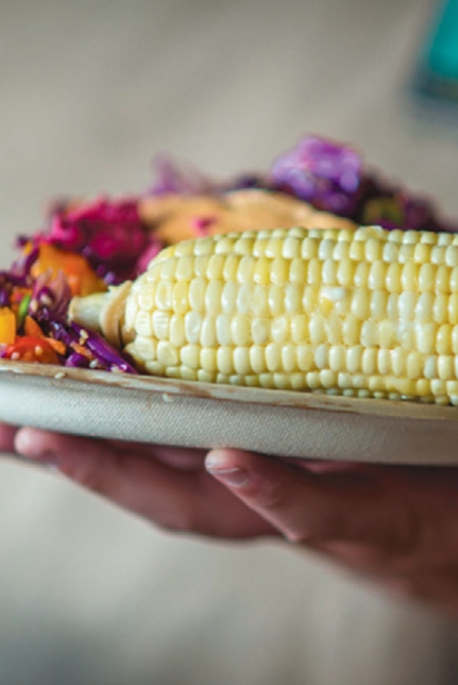 A plate with corn and other food